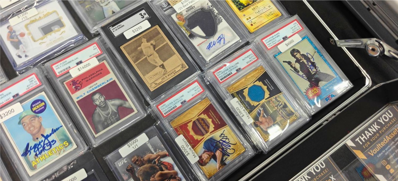 Display case of graded cards including vintage basketball, baseball and entertainment cards